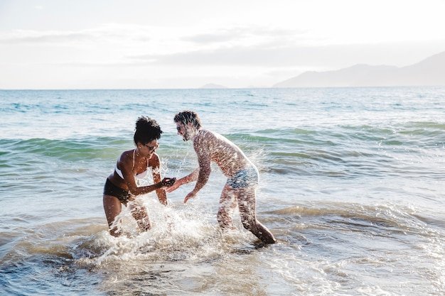 couple-having-fun-water-beach_23-2147648995